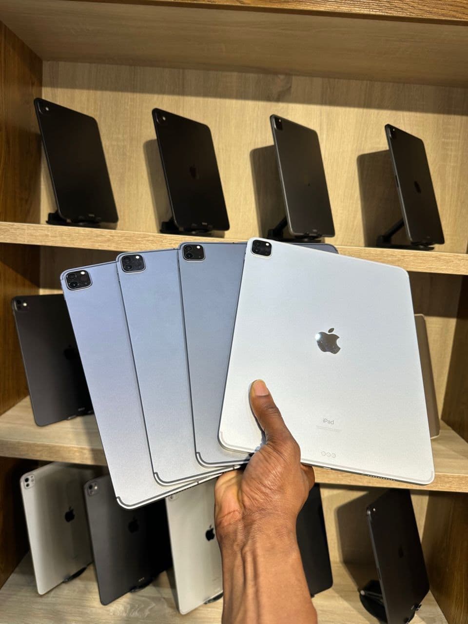Fanned iPad Pro units in front of shelf display