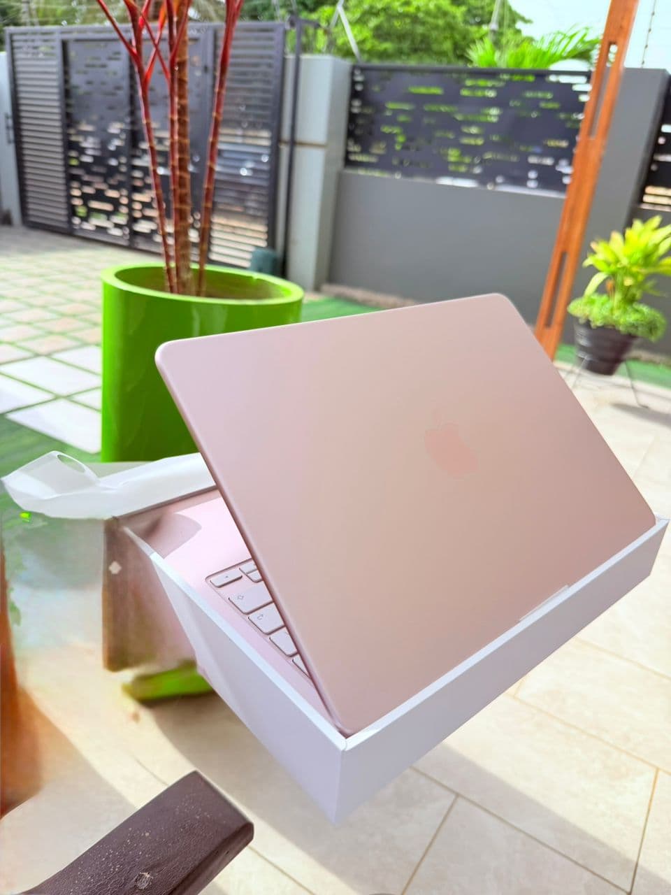 MacBook Air in pink being unboxed